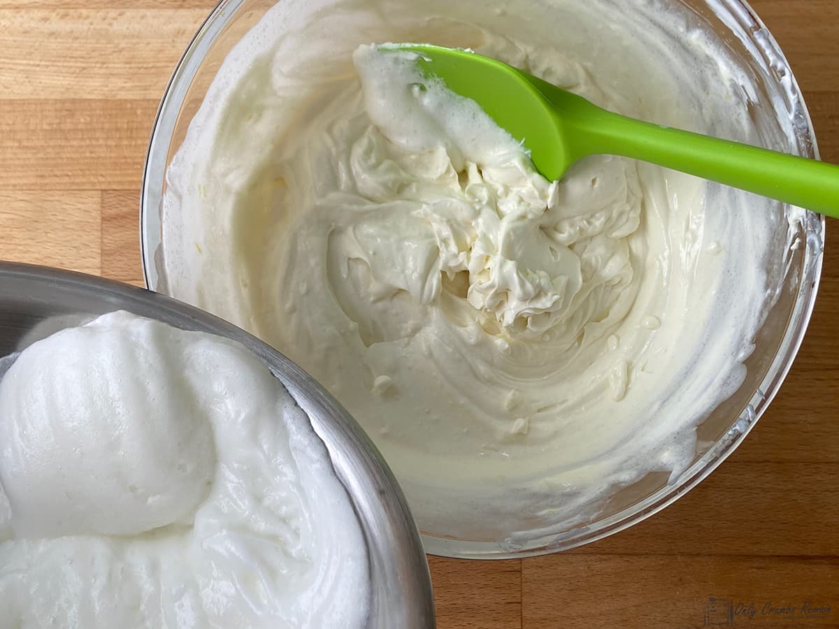 adding whisked egg white to cream cheese mixture.