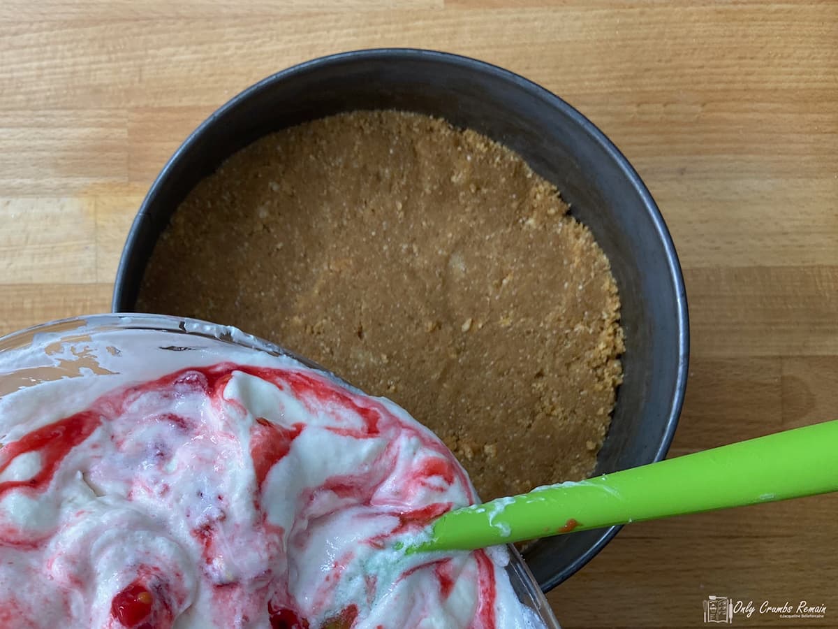 poring mixture onto biscuit base.