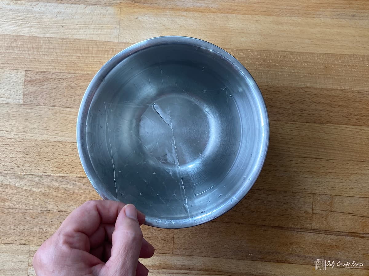 placing sheet gelatine ton a bowl of water.