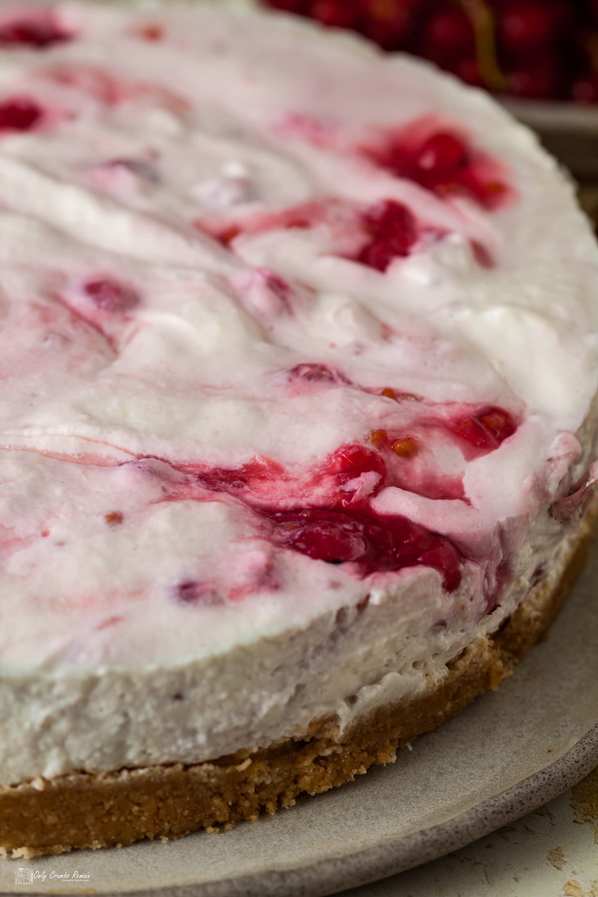 whole undecorated cheesecake on plate