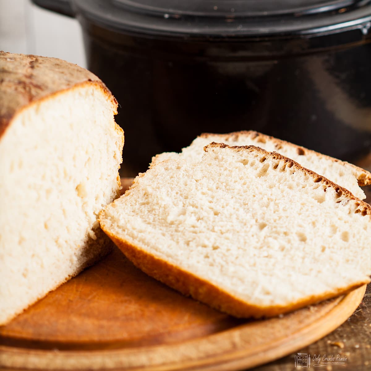 sourdough loaf cooked in casserole and sliced on board.