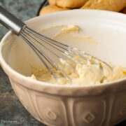 Crème Pâtissière in a mixing bowl with a ballon whisk.
