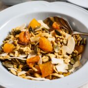 bowl of easy crunchy granola with apricots, pecans,and cocont