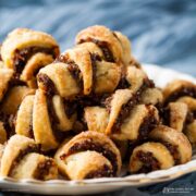 pile of Rugelach with mincemeat and almond filling piled on a plate.