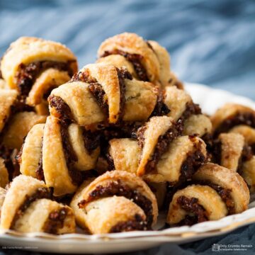 pile of Rugelach with mincemeat and almond filling piled on a plate.
