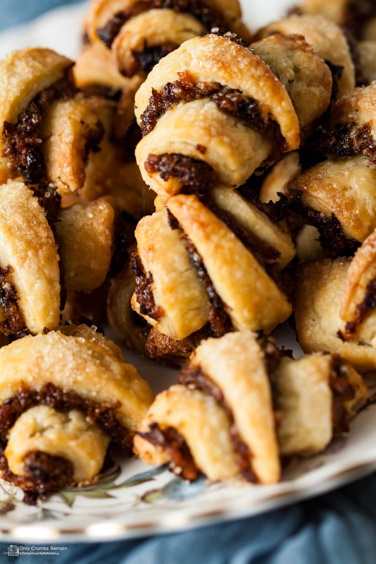 plate piled with Rugelach filled with a sweet mincemeat filling.